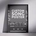 A black-framed poster mockup leaning against a light gray wall. The poster displays a music player interface with the text 'CUSTOM SONG POSTER' in large white letters, along with placeholder text 'Song Name' and playback controls.